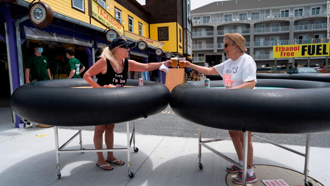 People try out &lt;a href=&quot;https://www.cnn.com/travel/article/coronavirus-restaurant-bumper-tables-trnd/index.html&quot; target=&quot;_blank&quot;&gt;social-distancing &quot;bumper tables&quot;&lt;/a&gt; as the Fish Tales restaurant opened for in-person dining in Ocean City, Maryland, on May 29.